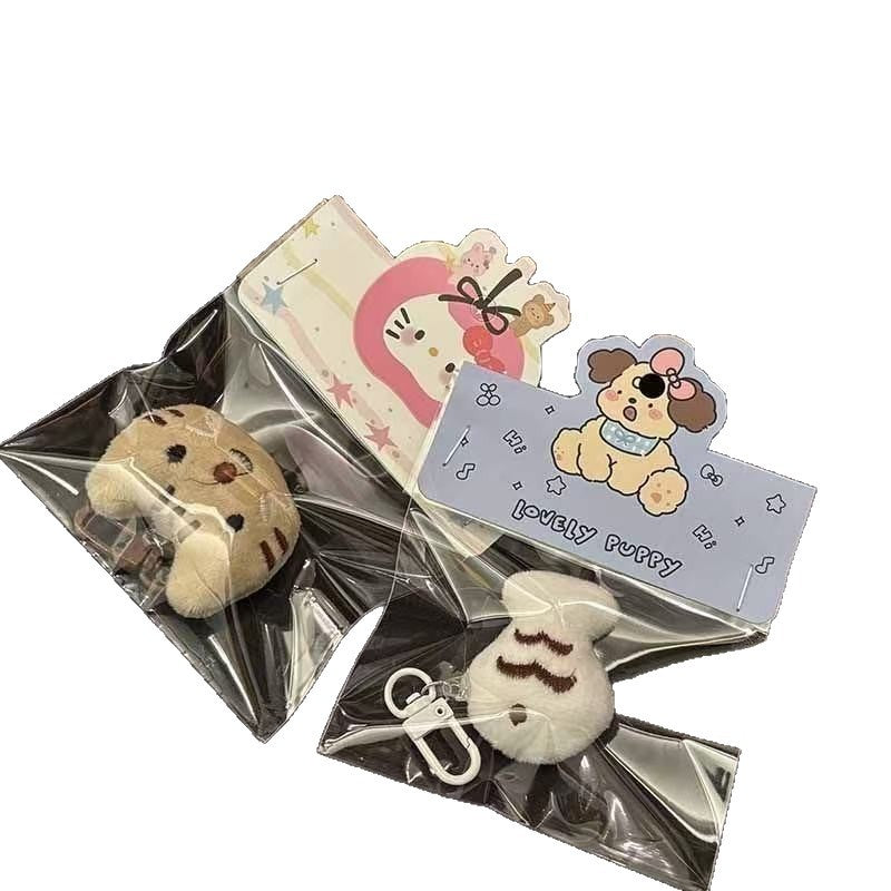 Cute plush doll keychains featuring animal designs and colorful packaging.
